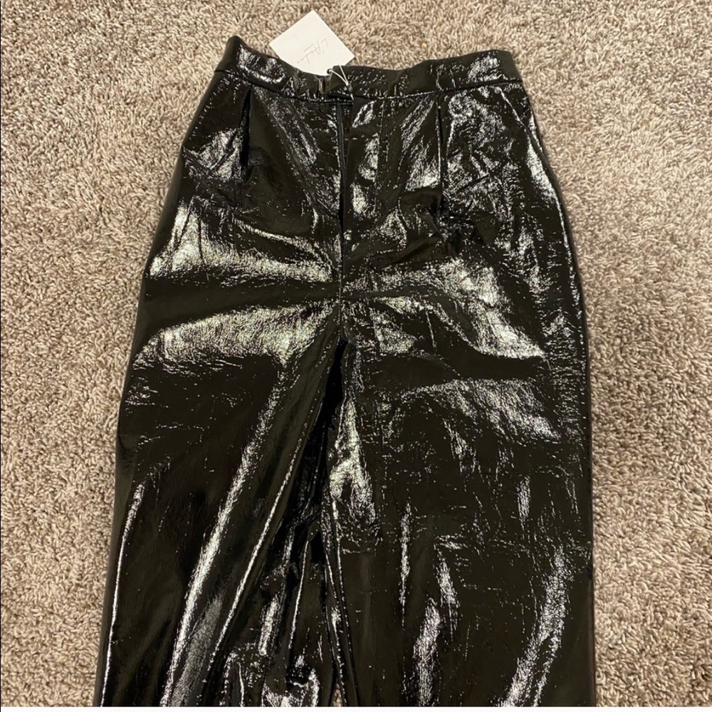 Black coated pants. Straight leg